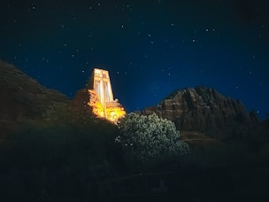 Sedona - Chapel of the Holy Cross golden lights at night with the twinkling stars above