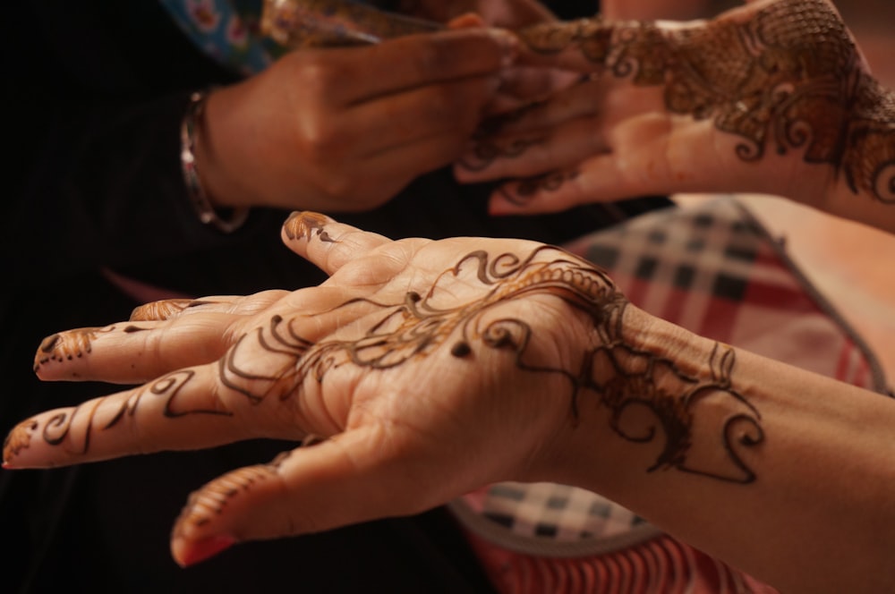 person showing hand tattoos