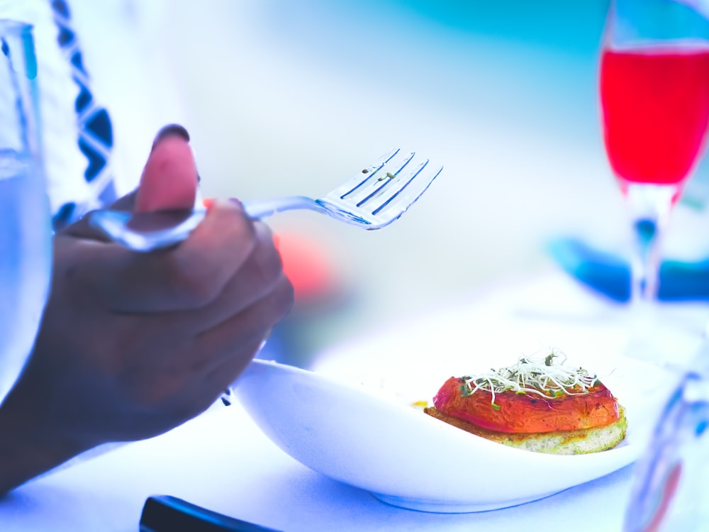 person holding stainless steel fork