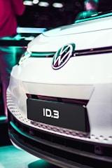 The Volkswagen ID.6 driving along the scenic Albanian coastline with happy passengers inside.