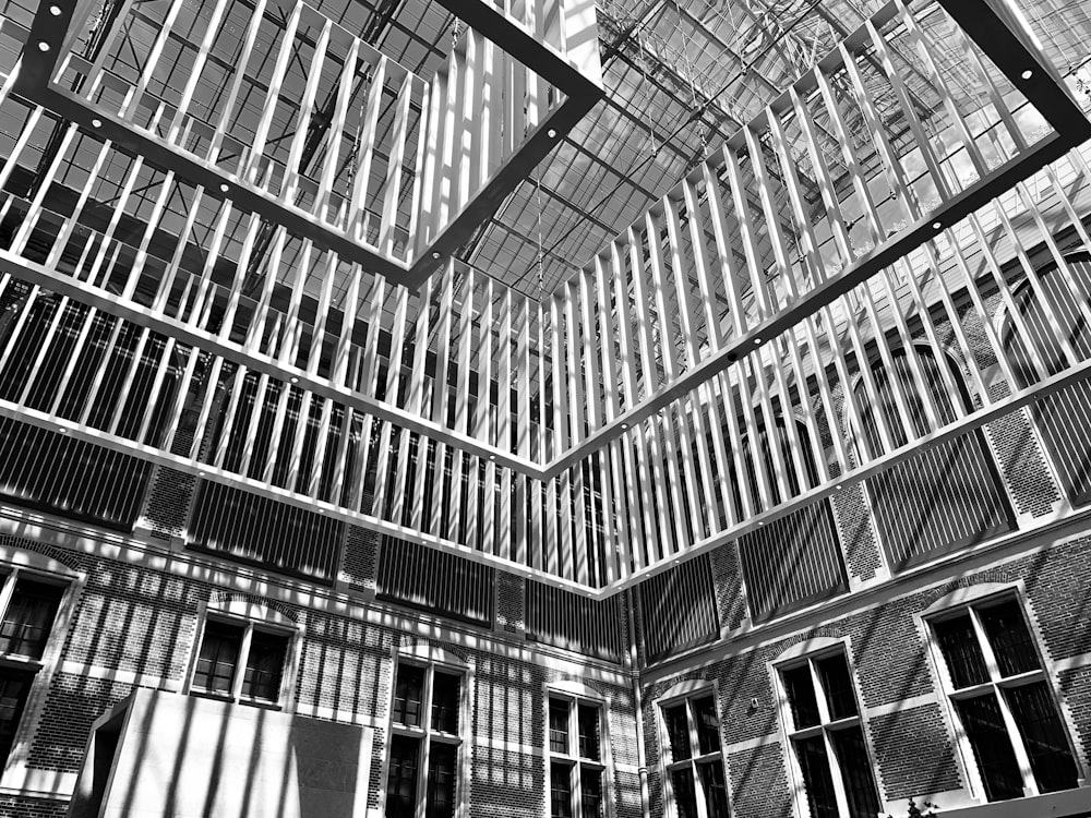 metal cages hanged on the roof grayscale photo