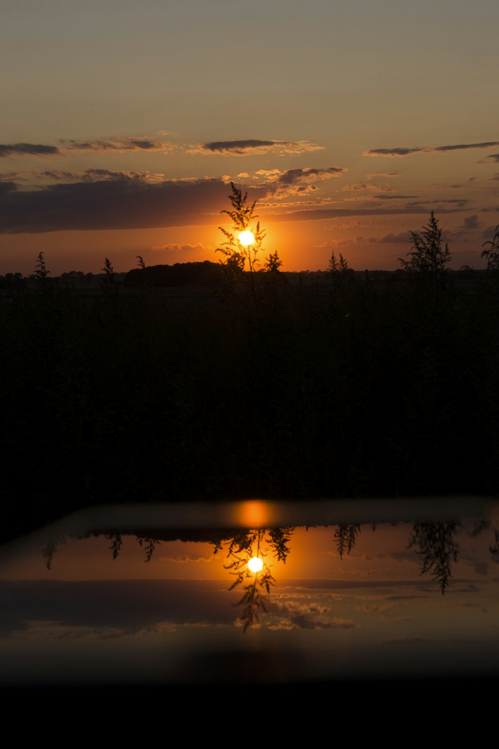 the sun is setting over a body of water