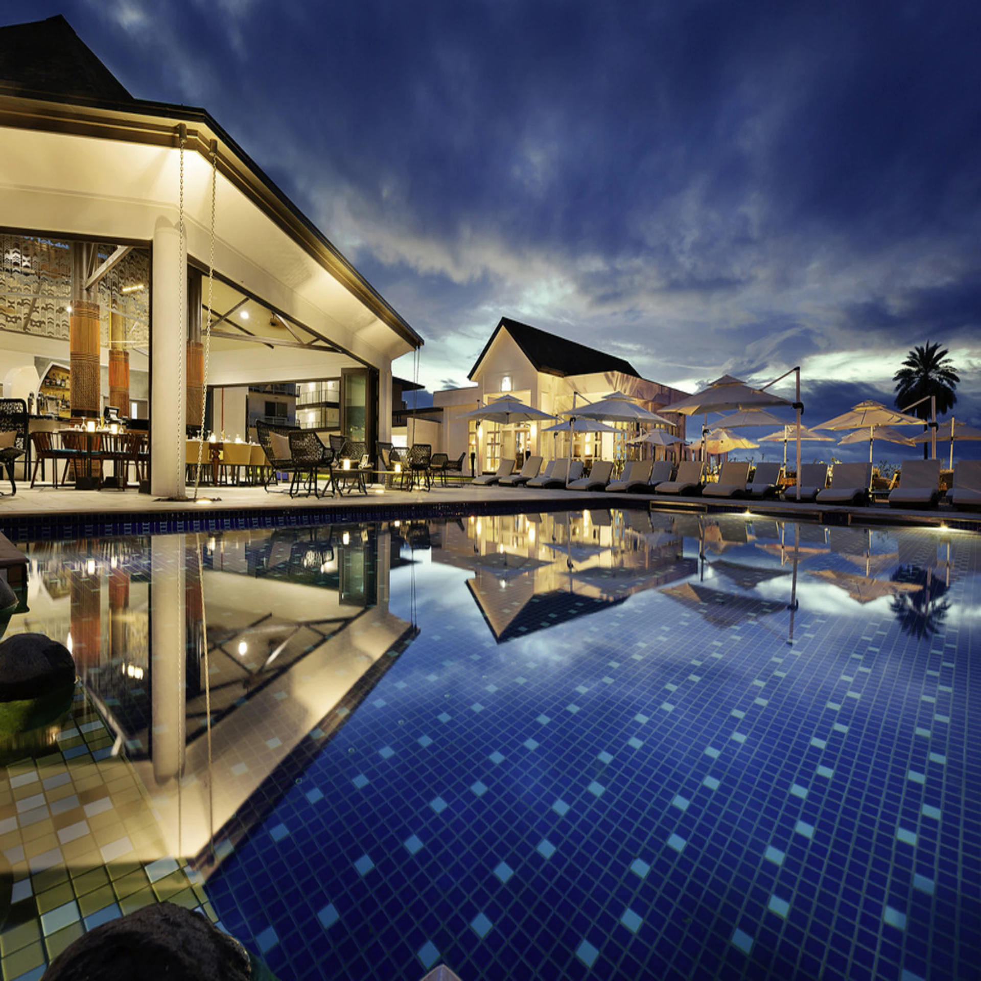 The Marisol at blue hour, its pool mirroring the last of the evening sky