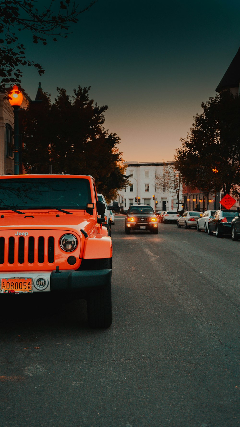 red Jeep Wrangler on sidewalk