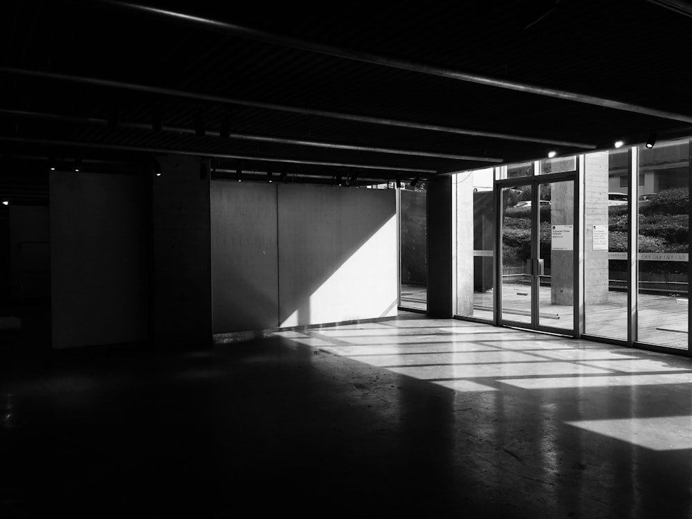 grayscale photo of full-glass door