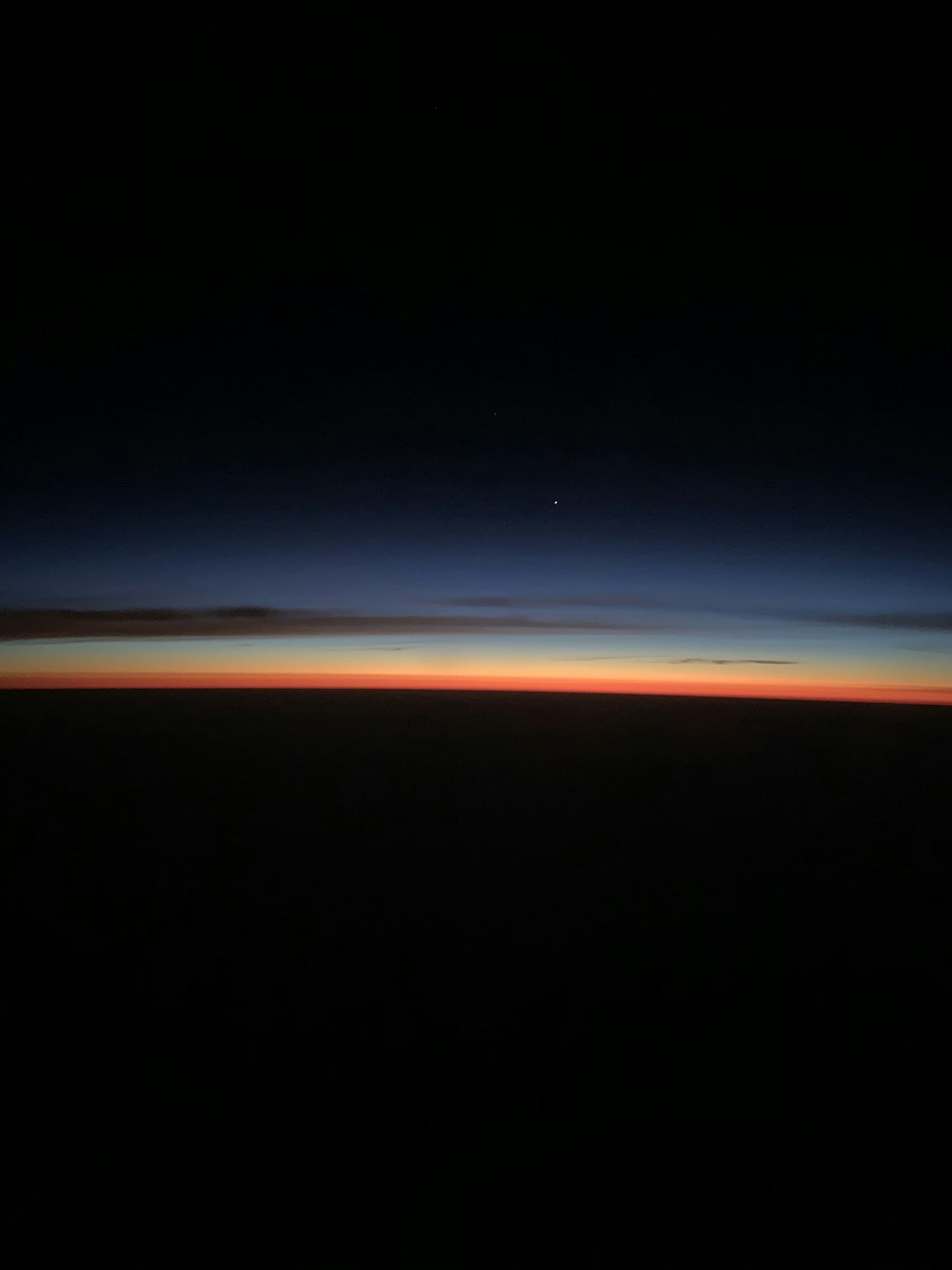 the sun is setting over the horizon of the earth