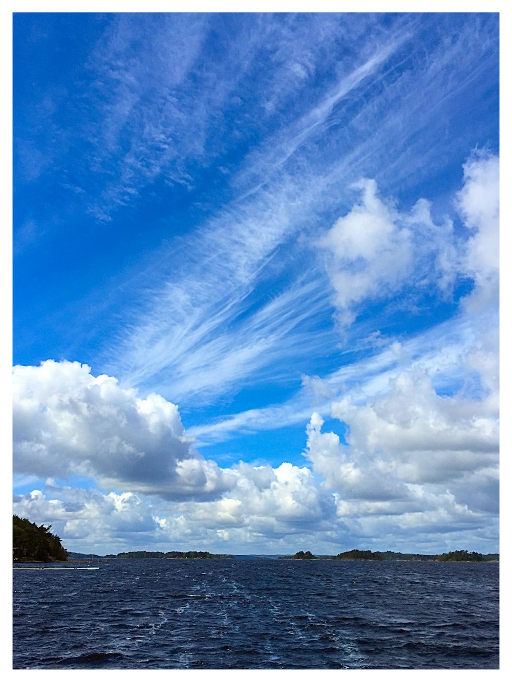 body of water under white sky