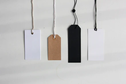 four blank paper pricing tags
