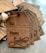 A stack of wooden gift tags with dark engraving, featuring spaces labeled 'To' and 'From Santa' with a decorative script for 'Santa'. The tags are tied together with brown string and a gold metal spiral decoration.