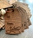 A stack of wooden gift tags with dark engraving, featuring spaces labeled 'To' and 'From Santa' with a decorative script for 'Santa'. The tags are tied together with brown string and a gold metal spiral decoration.
