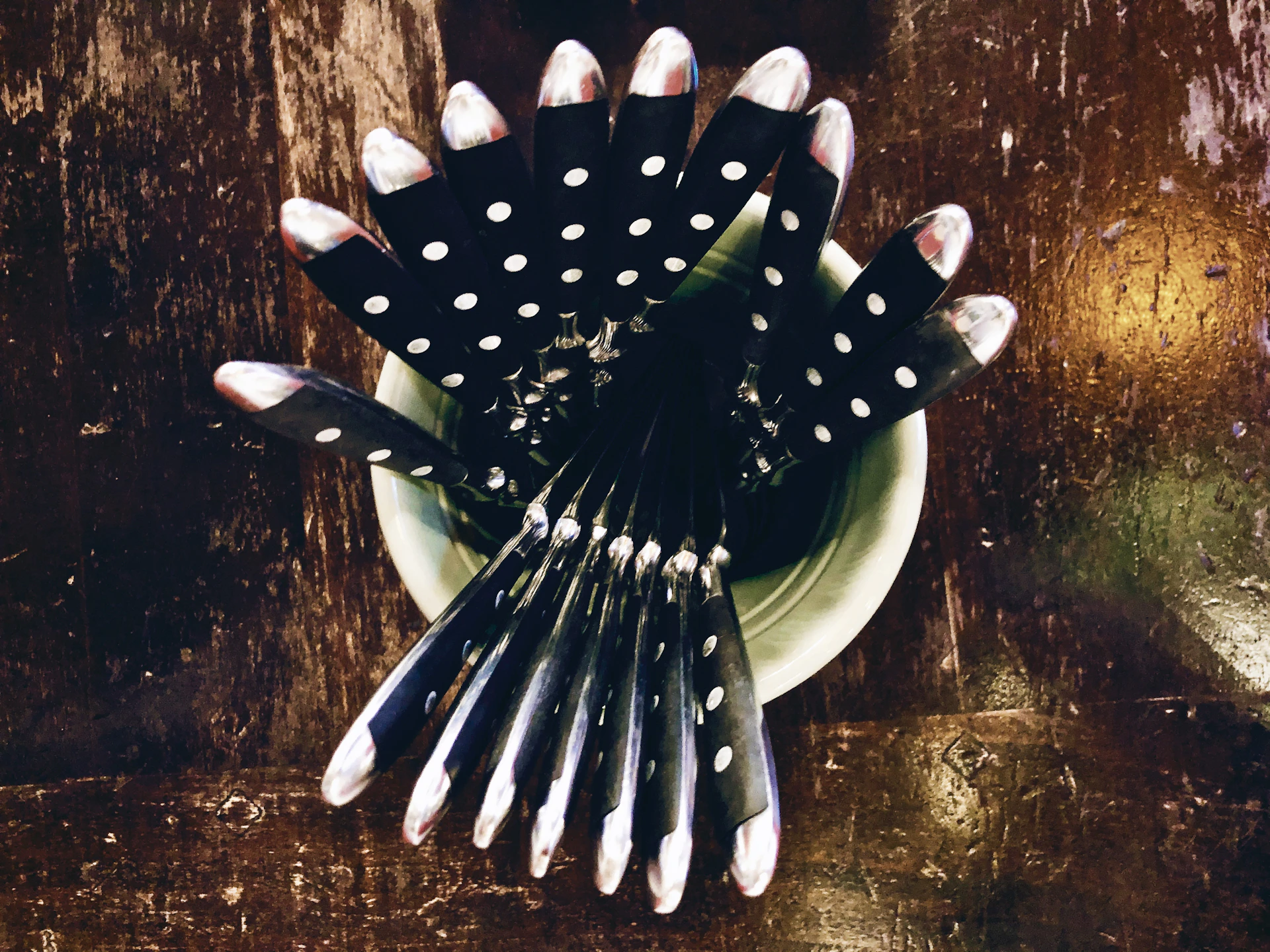 Close-up of a happy customer holding the facaviva 6-piece non-stick knife set in a bright kitchen.