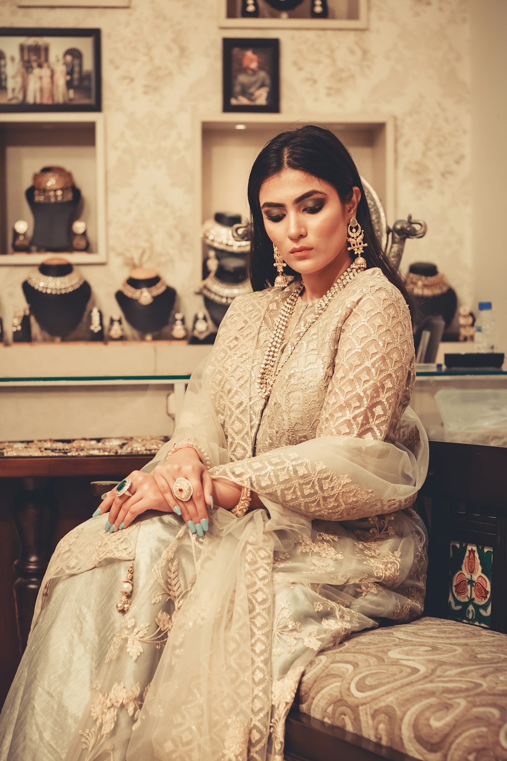 woman in white dress sitting on ottoman