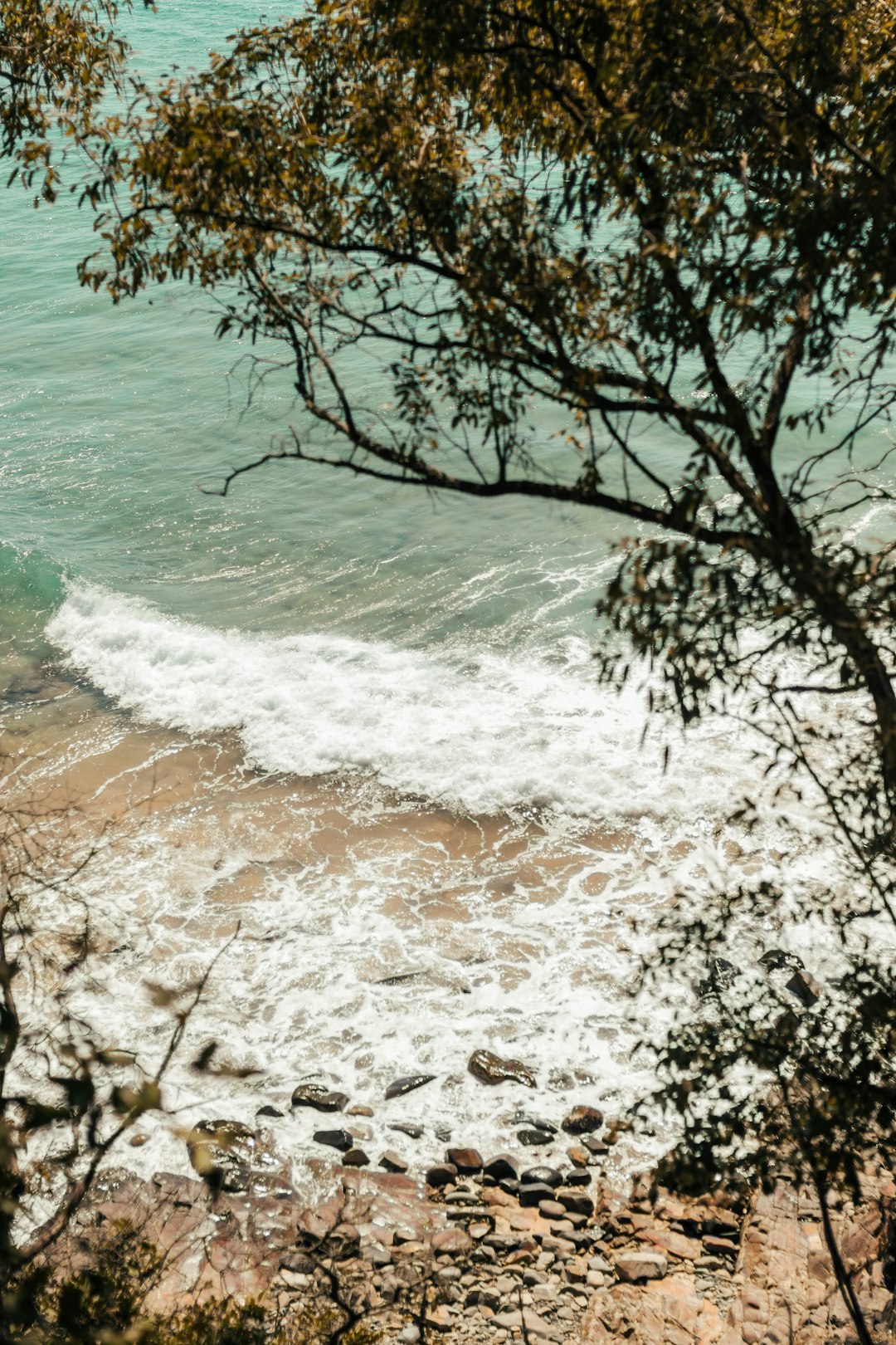 water crashed into the seashore at daytime