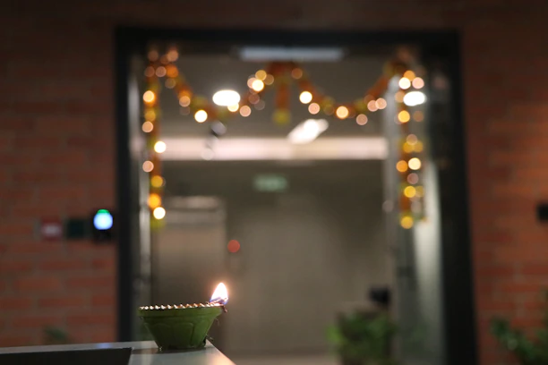 A cozy Diwali setup featuring elegant diyas and festive decorations glowing warmly in a living room.