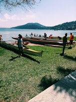 Smiling participants preparing their canoes on the sandy beach before a weekend tour.