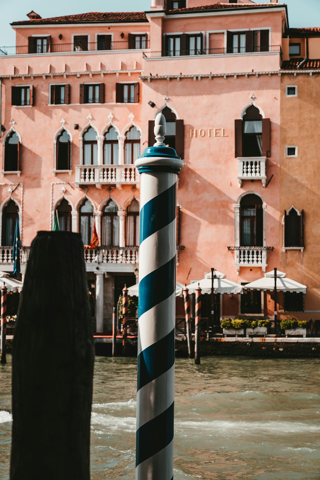 blue and white post near body of water