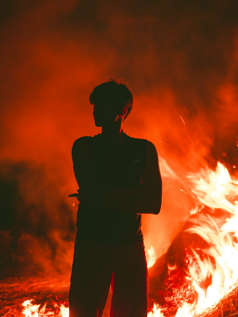 a person standing in front of a fire