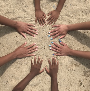Hands of various skin tones joined together forming a circle.