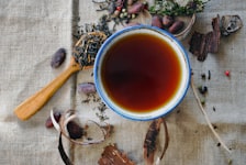 Masala chai in cup with cardamom pods