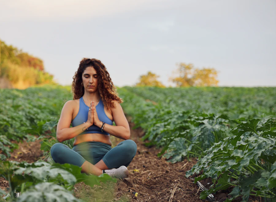 Woman meditating in a green field
