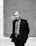 greyscale photo of man in suit