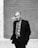 greyscale photo of man in suit