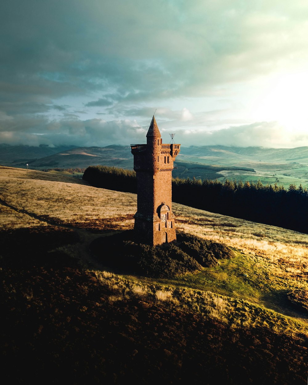 brown stone tower on hill