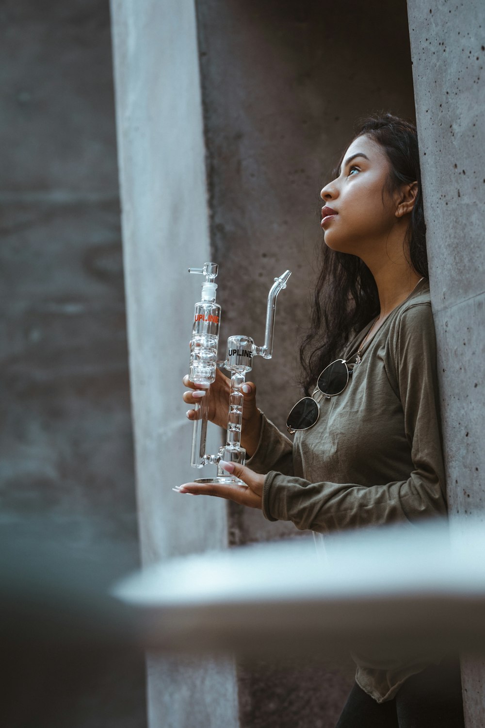 woman holding glass water bong