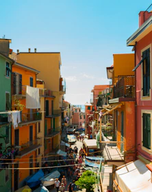 A bustling Colombian city street alive with colorful buildings and lively markets.