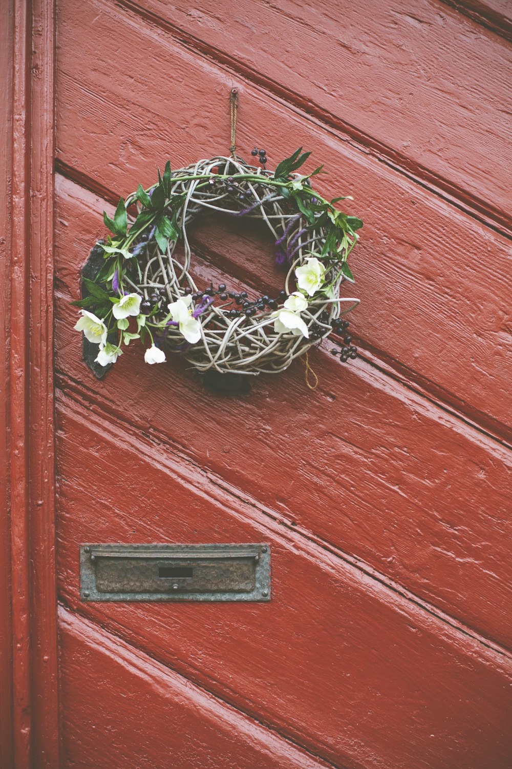 green and white floral wreath on wall