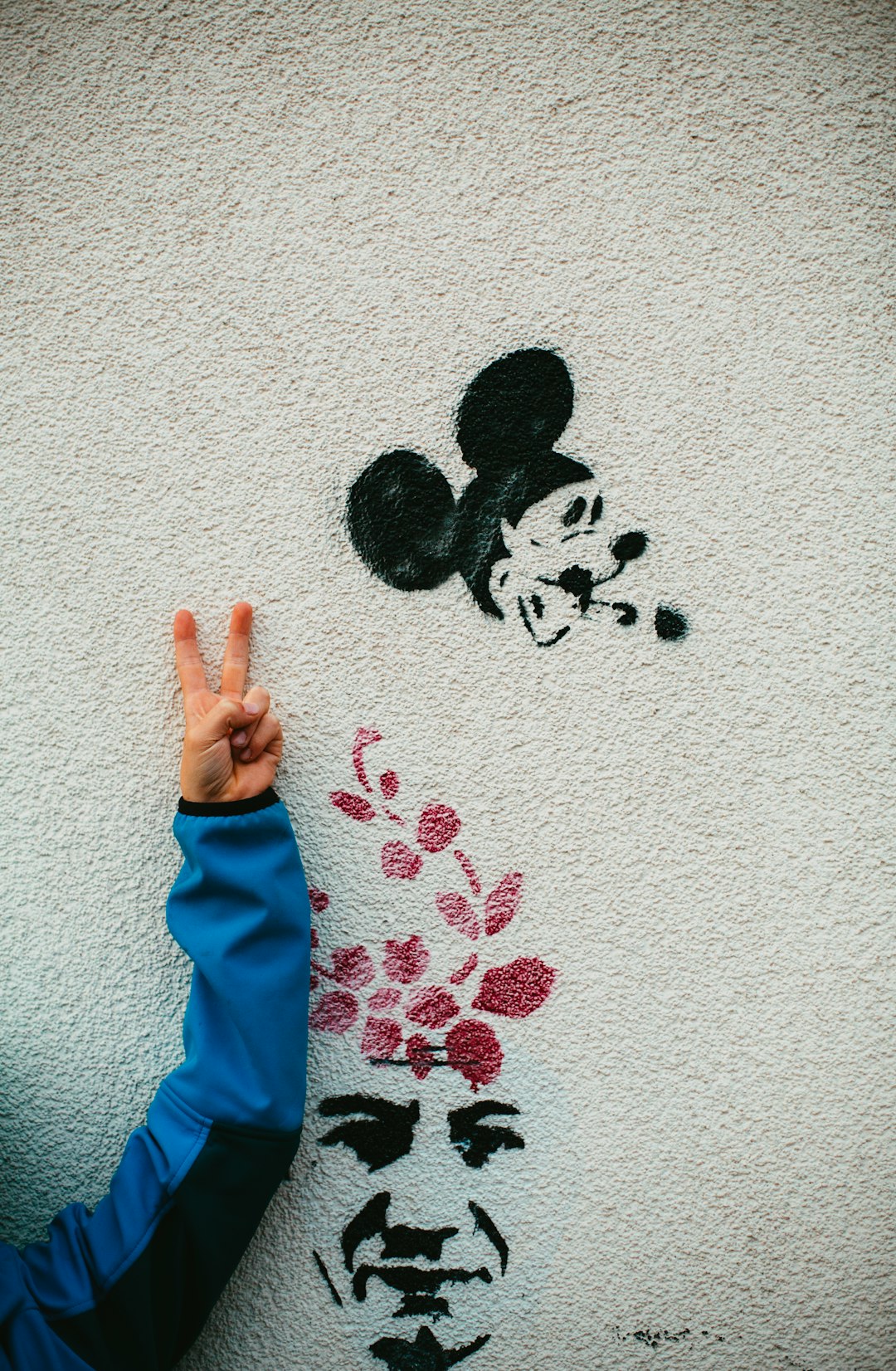 Mickey Mouse and man's face painted on the wall