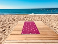 red and white yoga mat on wooden board
