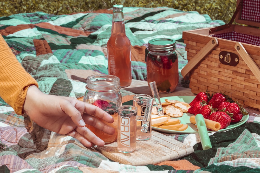 person touching clear glass jar