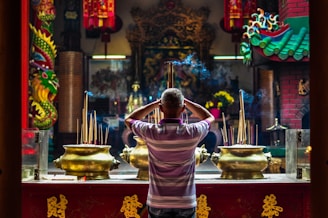 A serene altar with lit incense sticks filling the air with fragrant smoke.