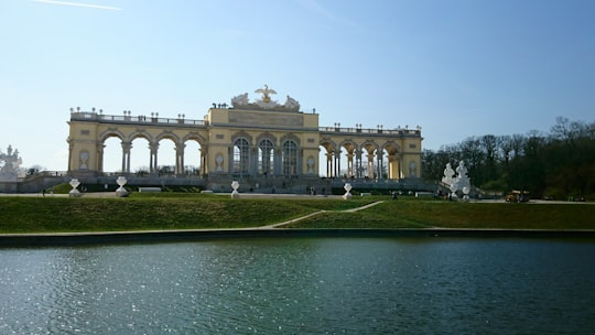 white and brown concrete building in Schönbrunner Schloss Park Austria