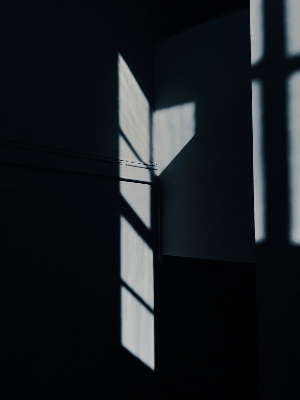 the shadow of a window in a dark room