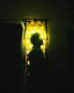 A dark space backdrop with a silhouette of the main character laughing under distant stars.