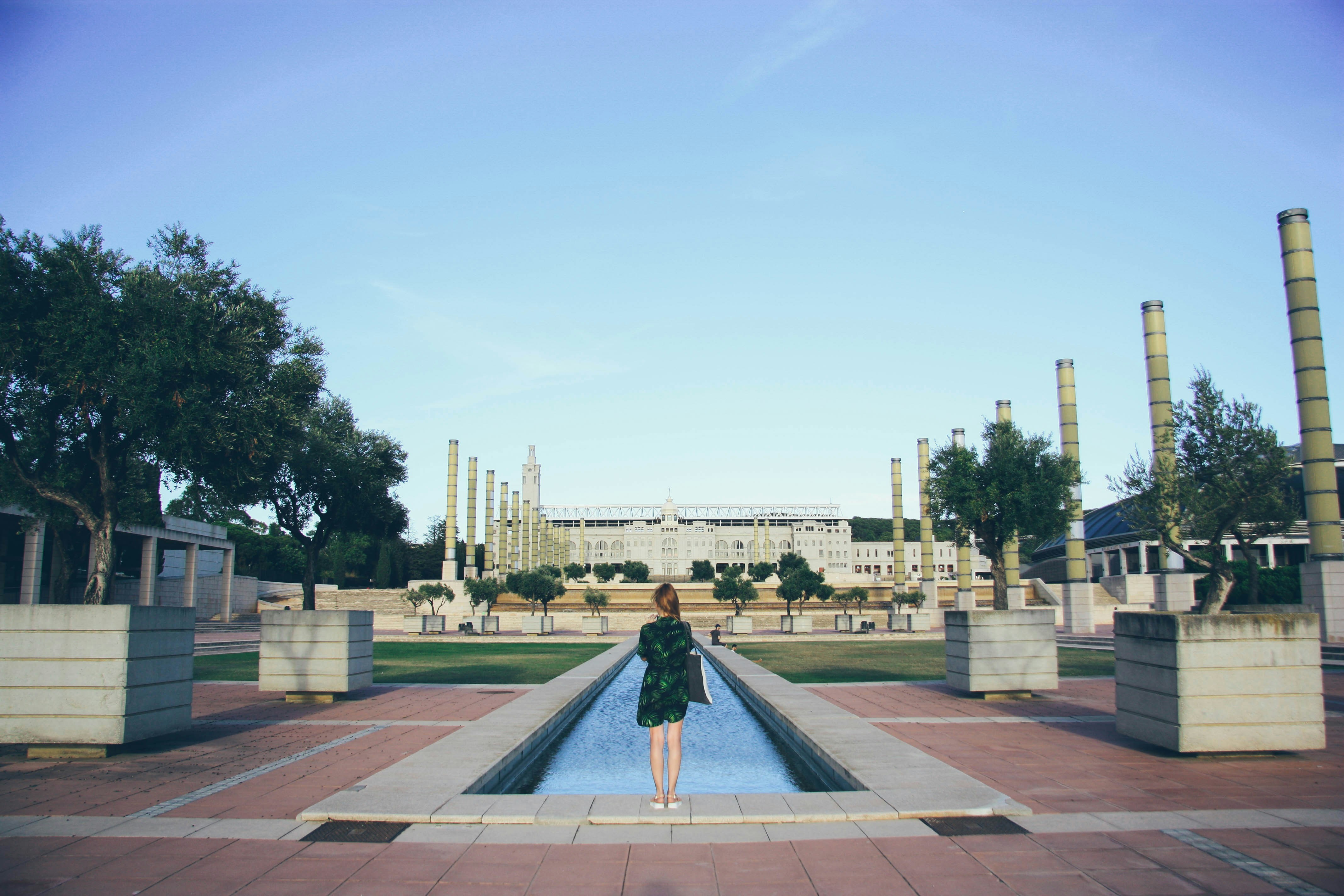 woman standing in front of swimming pool, Girl and Olympic village and pool