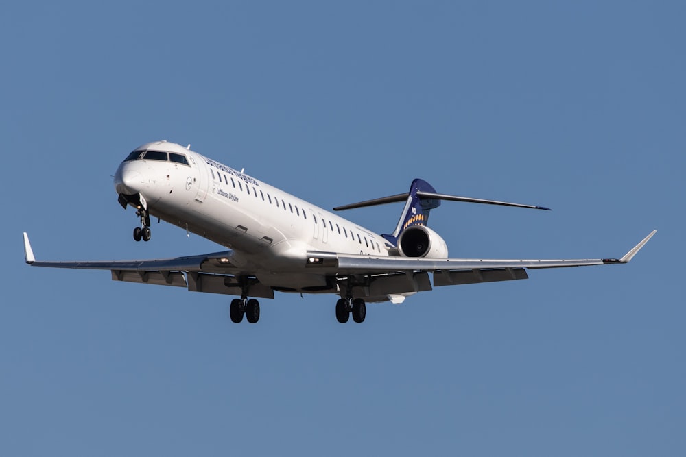 flying gray airplane during daytime