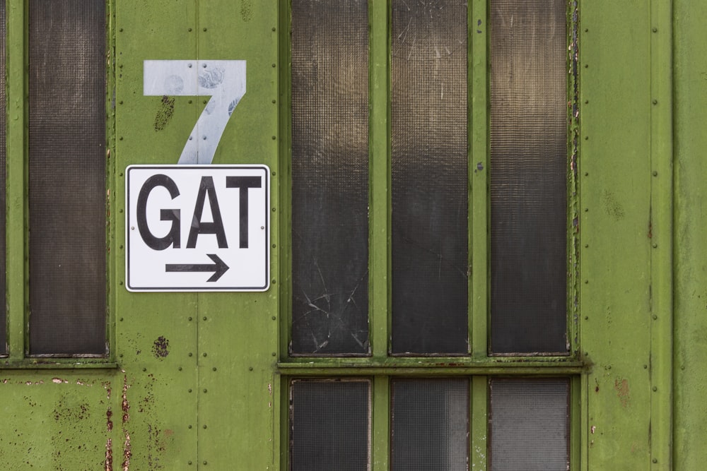 GAT signage on green glass door