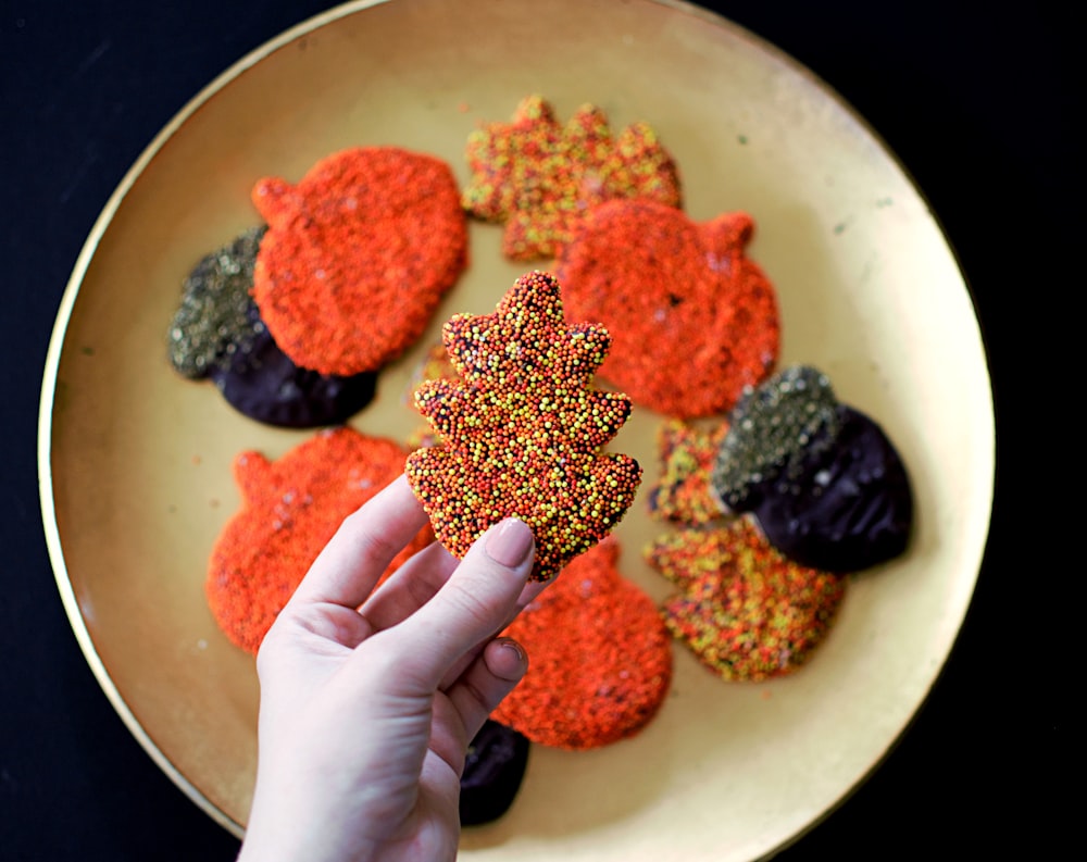 person picking Christmas tree themed cookie