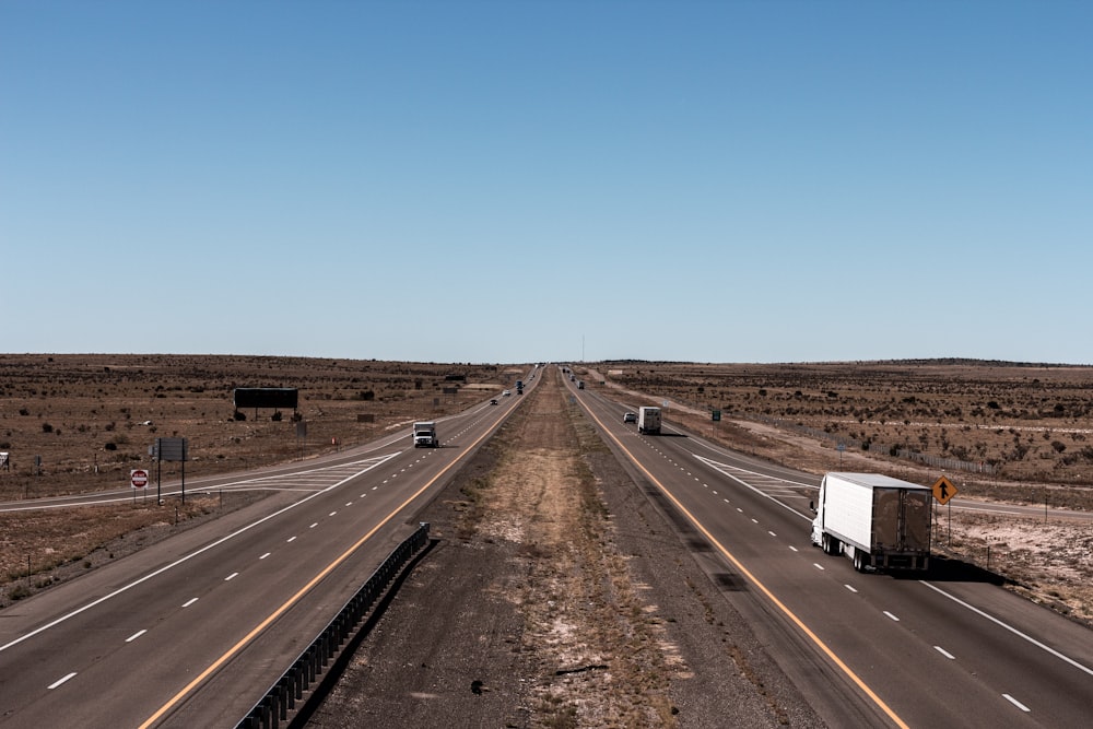 vehicles on road under blue calm sky