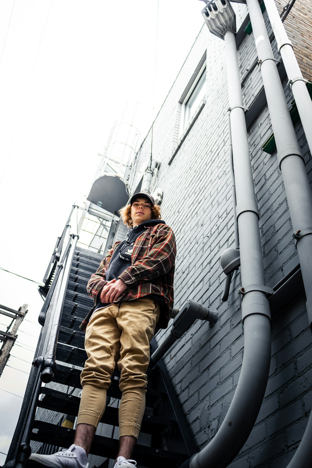 man standing on black metal ladder