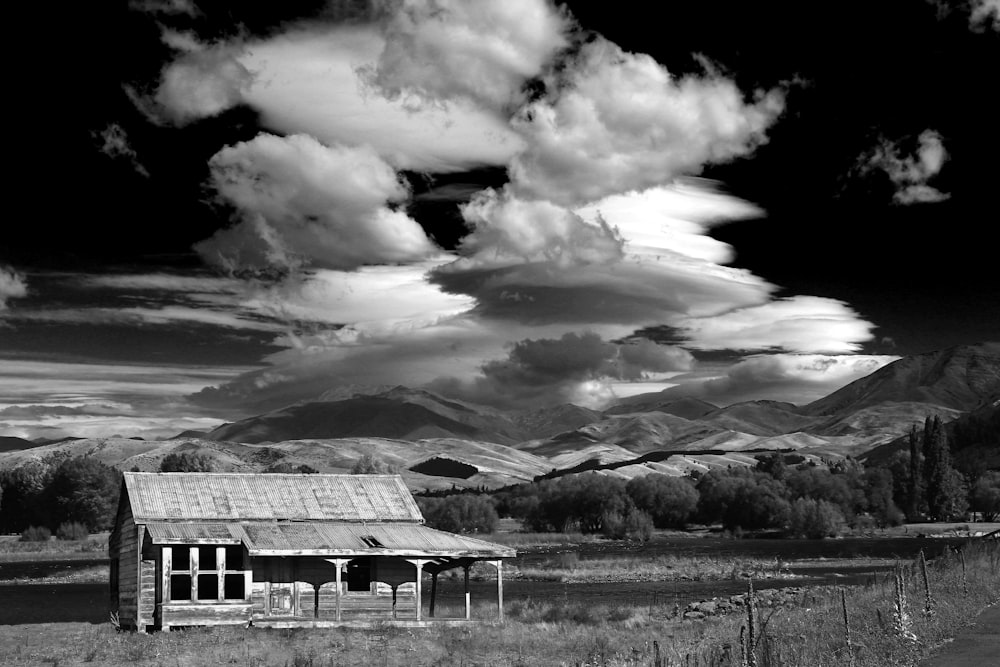 greyscale photo of house on field