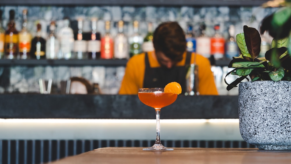 man standing and looking down in bar