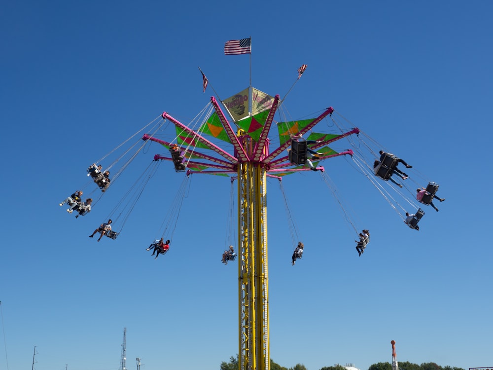 people riding in amusement park during daytime
