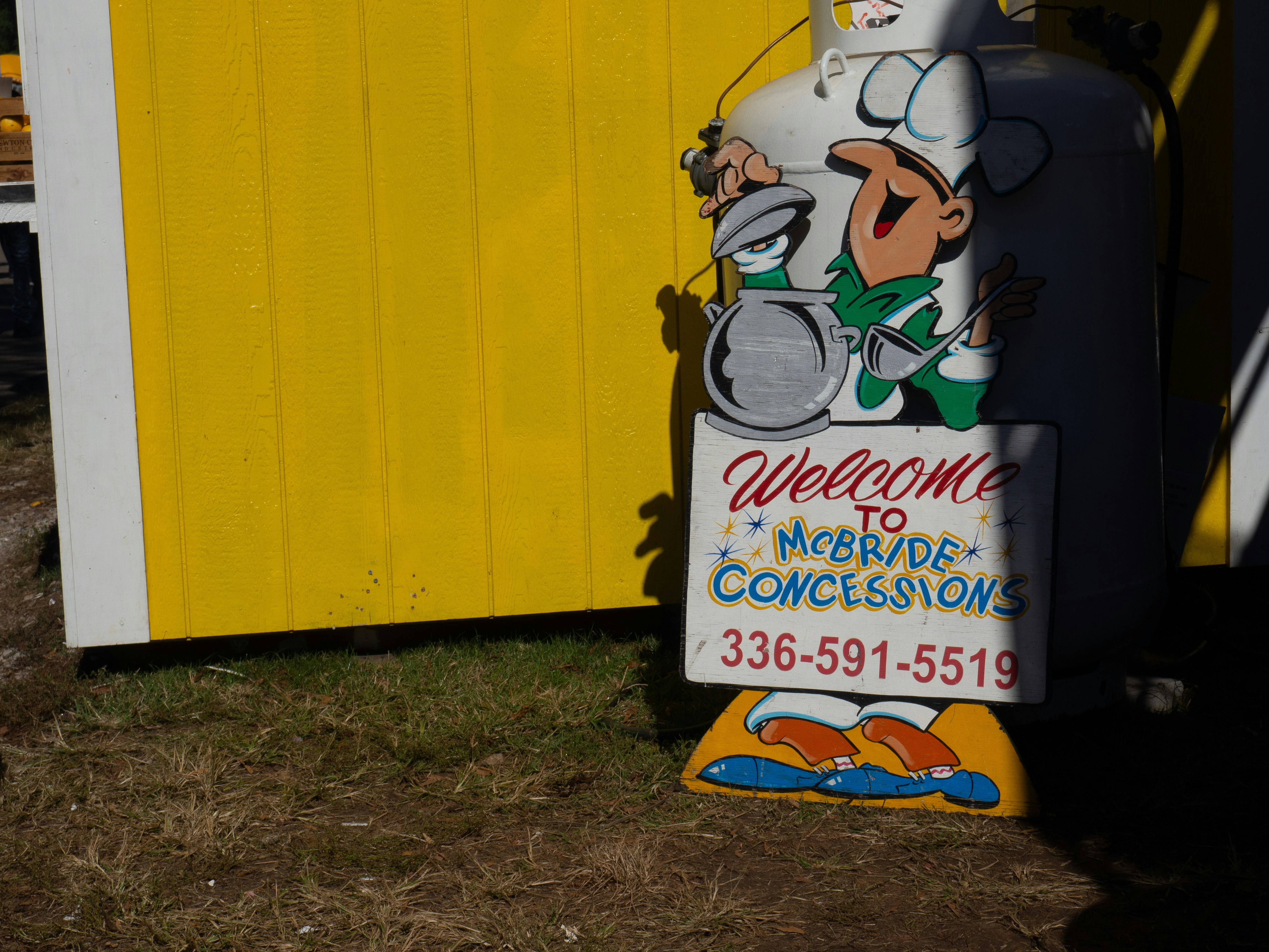 Male chef with welcome to Mcbride Concessions banner photo – Free Brown