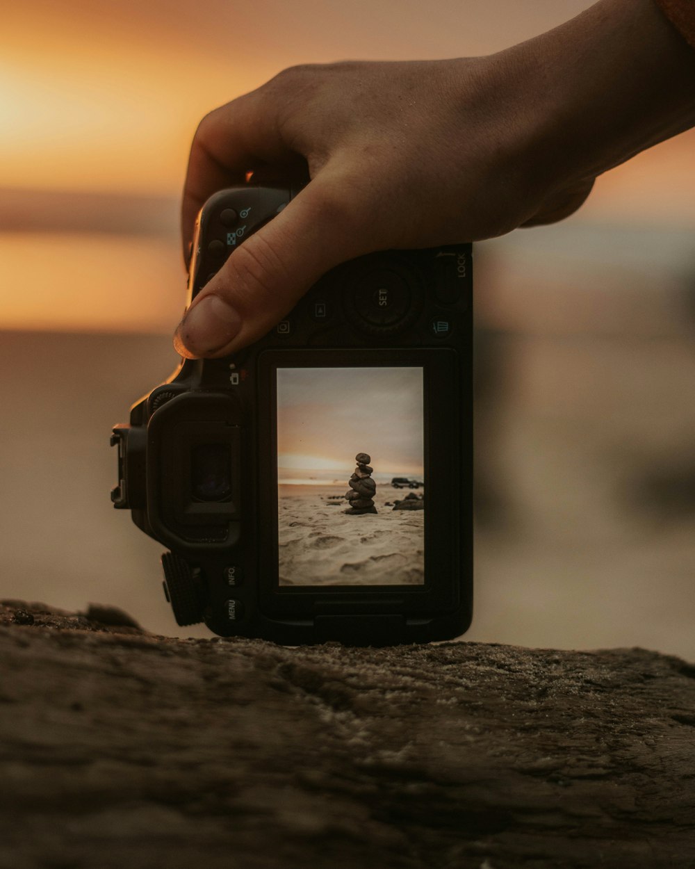 DSLR camera capturing stack of stones