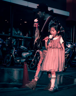 A mother and daughter sharing ice cream on a sunny afternoon stroll.