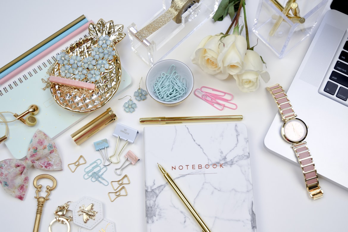 stationary and jewelry on a table